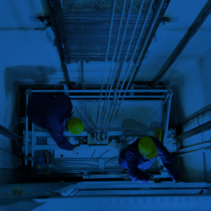 Elevator constructors working in an elevator shaft