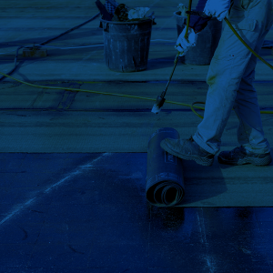 A roofer applying a torch down roof