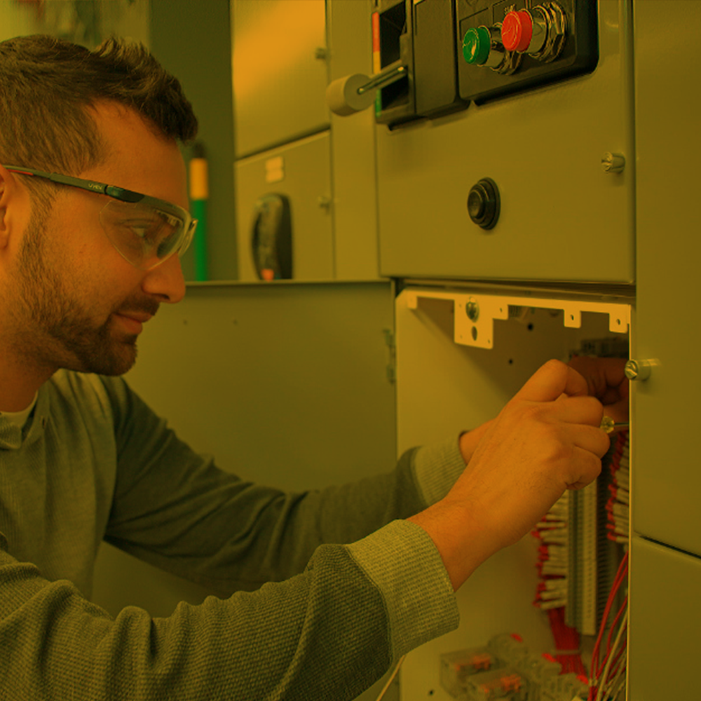 Inside electrician working on a control panel